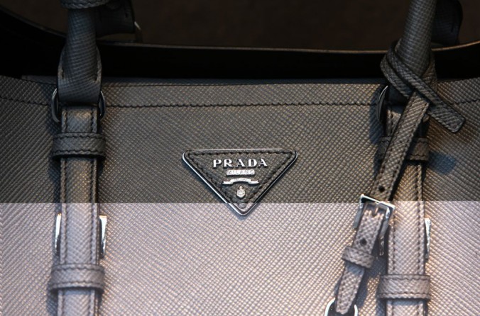 A Prada logo sits on the side of a women's bag displayed for sale in the window Prada SpA luxury store on Sloane Street in London, U.K., on Wednesday, Sept. 24, 2014. The pound rose to the strongest level in two years versus the euro amid bets the Bank of England is moving closer to increasing interest rates as its euro-area counterpart boosts stimulus. Photographer: Chris Ratcliffe/Bloomberg via Getty Images